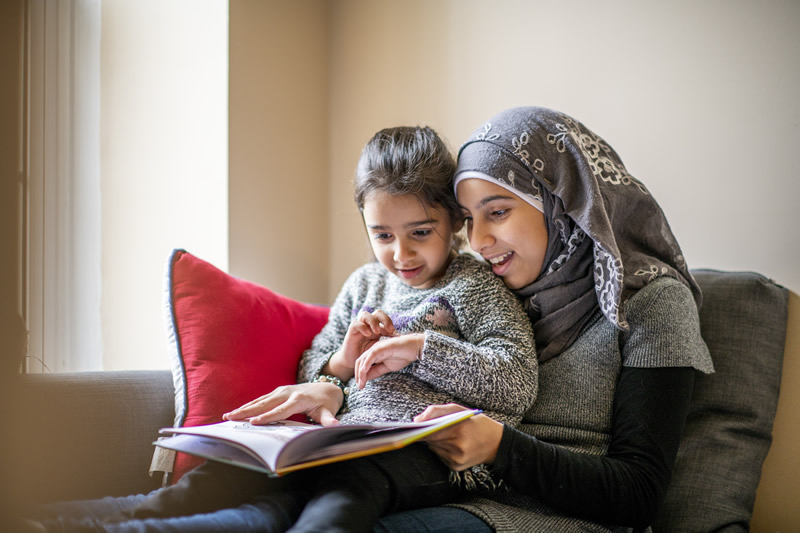A photo of a mom reading with her daughter