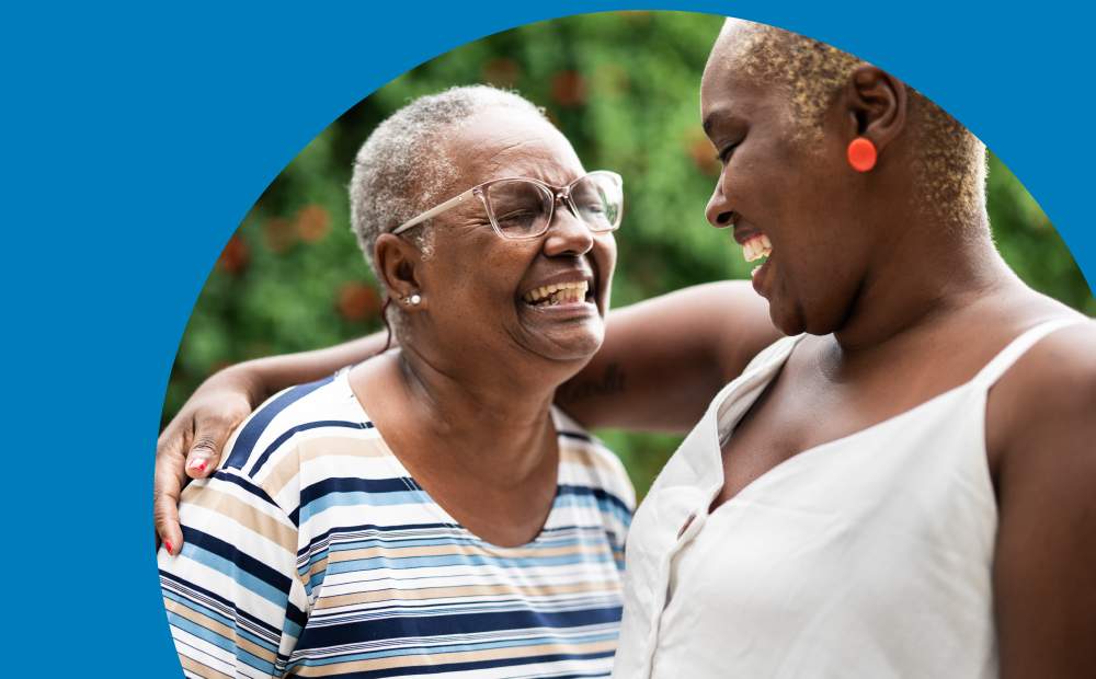 Two people of different generations smiling and embracing outdoors, expressing warmth, connection, and community care. Beside them, a blue background features the message: “Together, we can create a brighter tomorrow.”