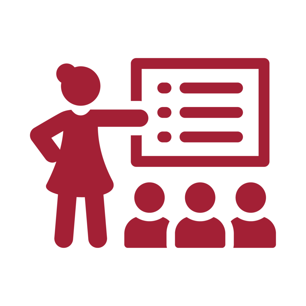 An icon of a school teacher teaching a class full of students.