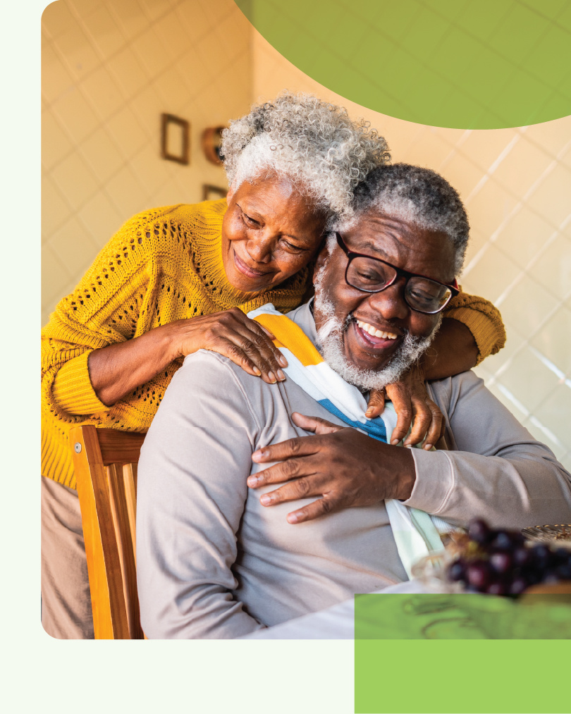 A photo of an older couple laughing together.